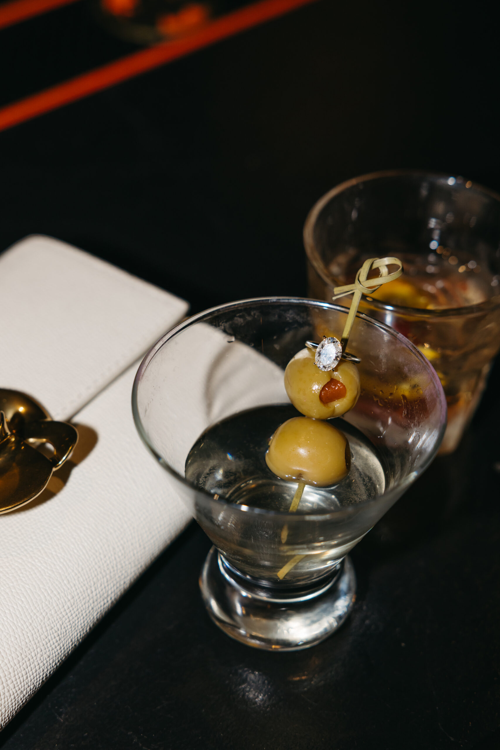 ring detail shot at a dimly lit bar while sharing drinks during engagement session in Scranton