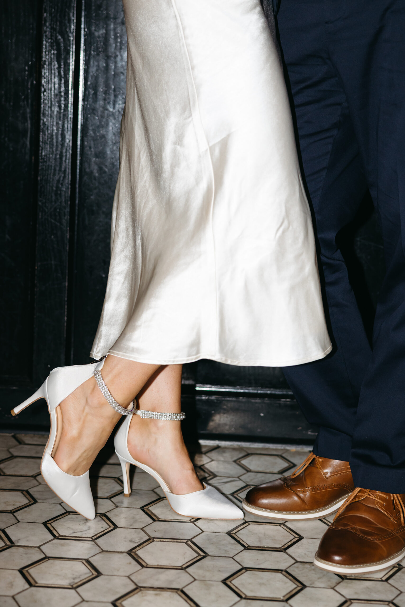 Couple sitting at a dimly lit bar sharing drinks during engagement session in Scranton
