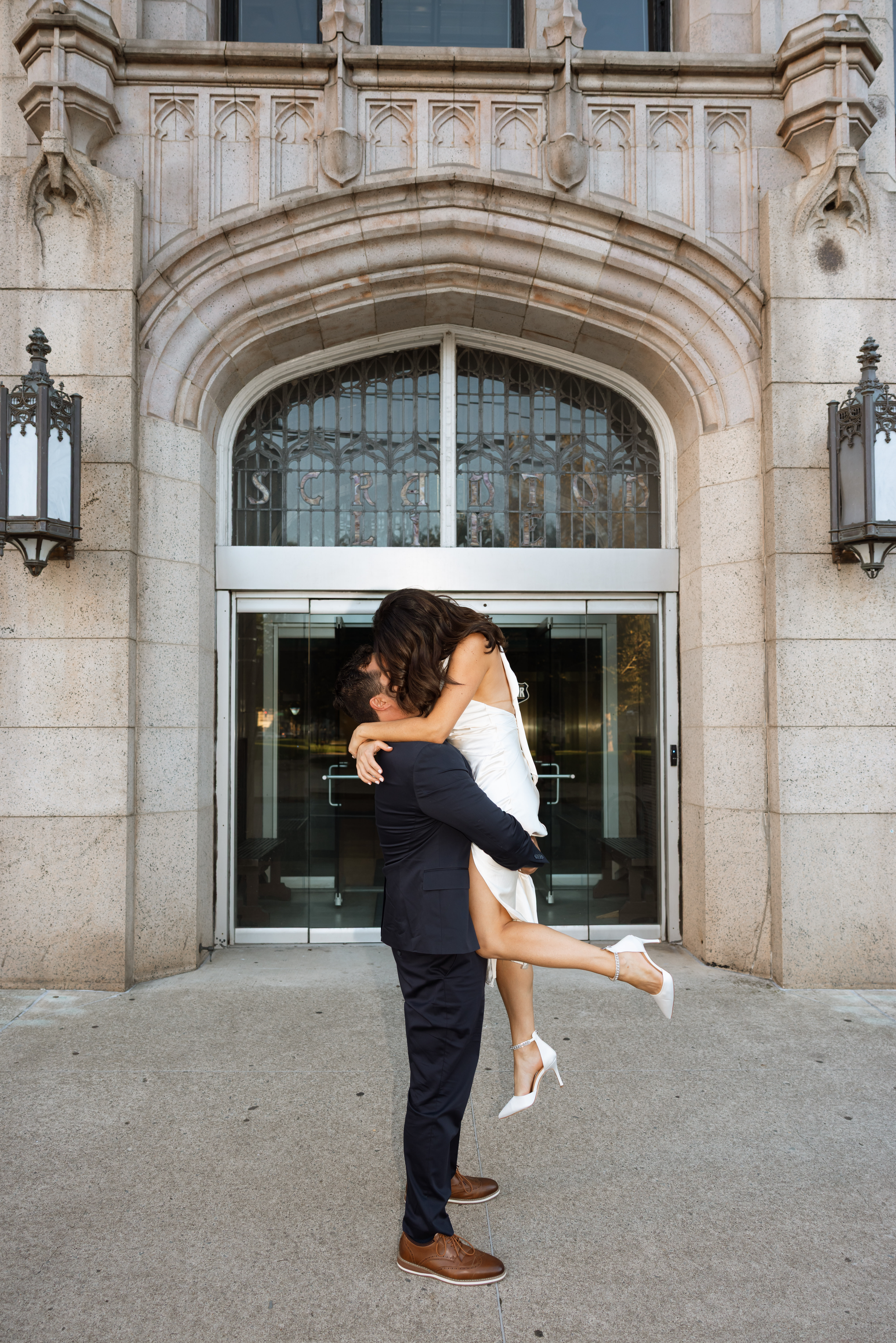 Engagement photos in Scranton, PA featuring city architecture and downtown vibes