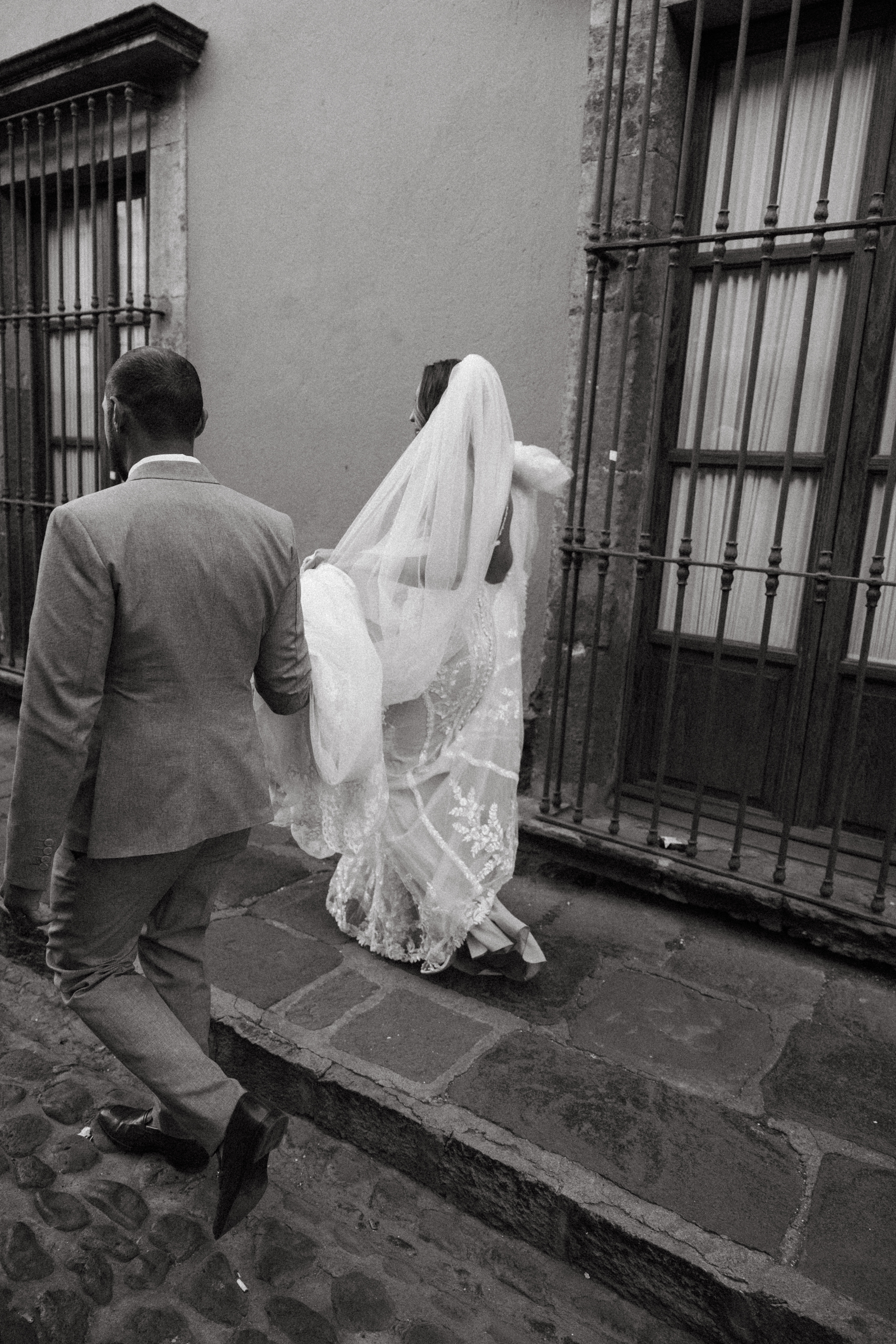 Couple walking through San Miguel de Allende just after getting married