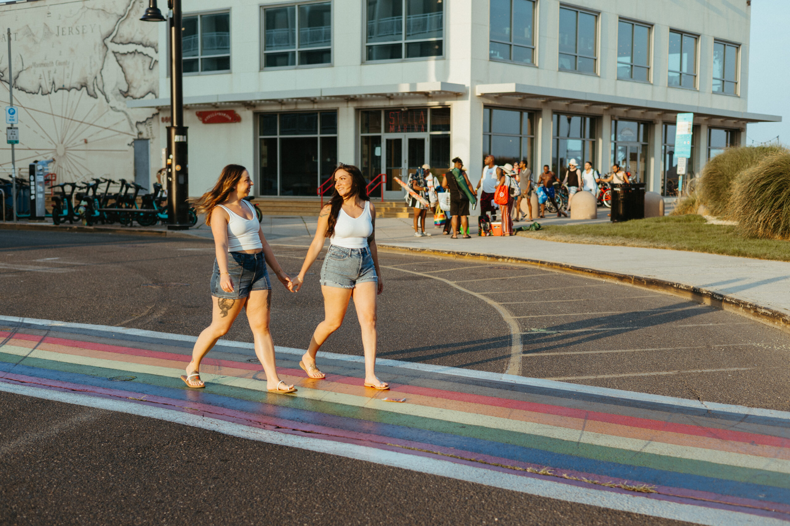 Couple walking along Asbury Park boardwalk holding hands