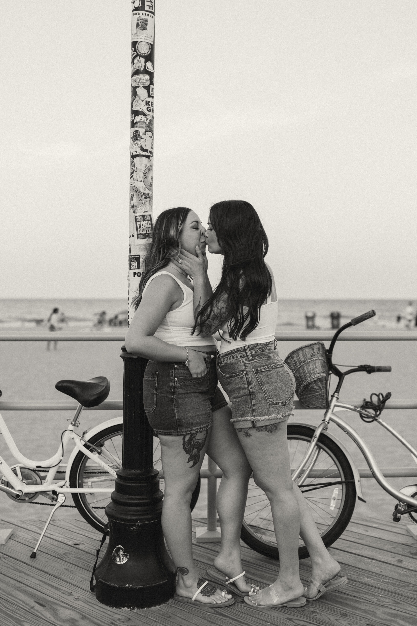 Couple walking along Asbury Park boardwalk with bicycle 
