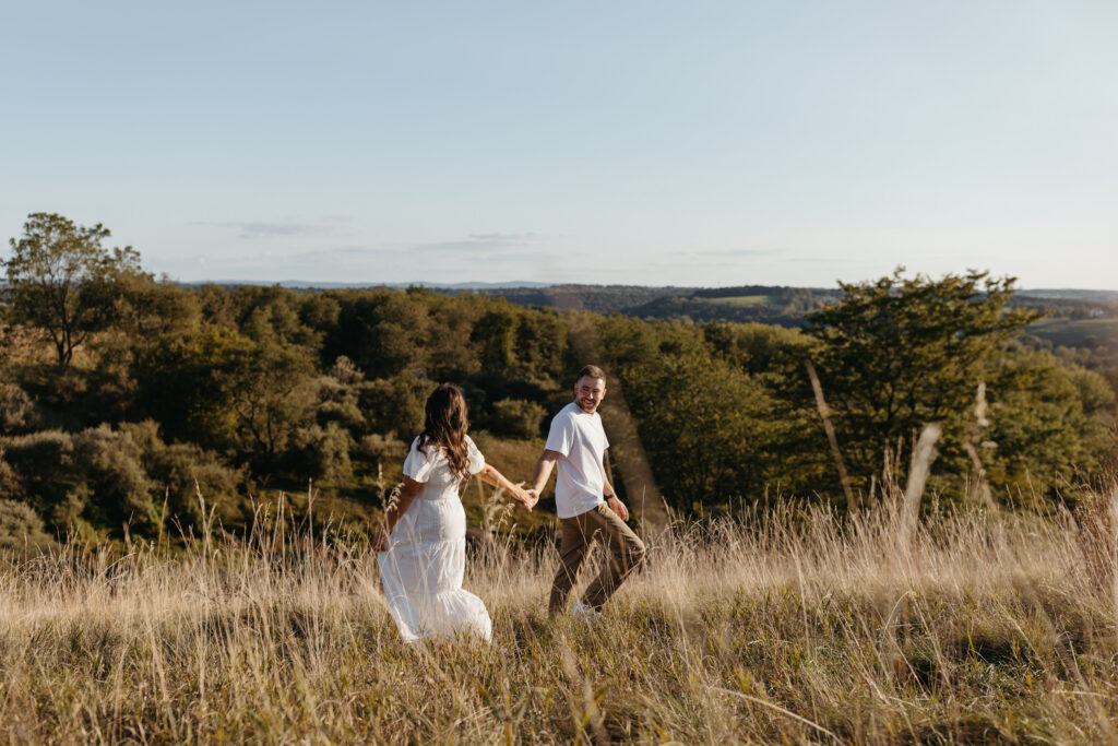 Natural, candid field couple photos created through guided prompts in Lehigh Valley Pennsylvania at golden hour